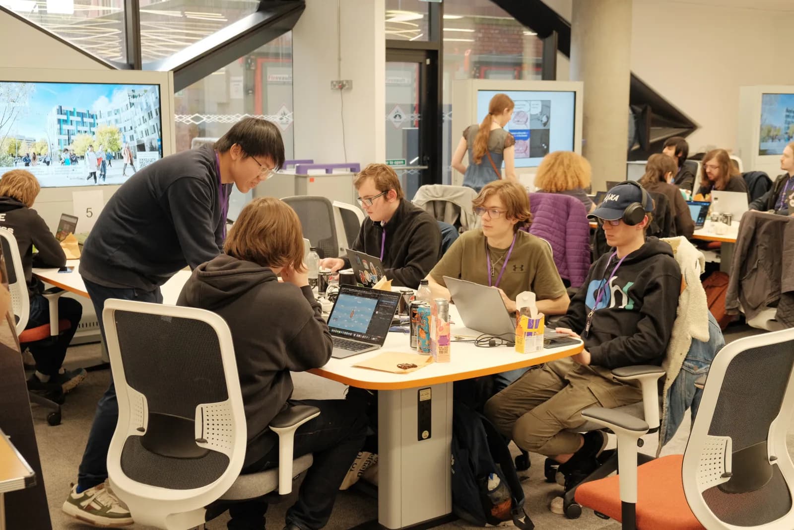 A hackathon team working around a table